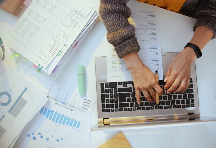 accountant woman with documents and laptop working.